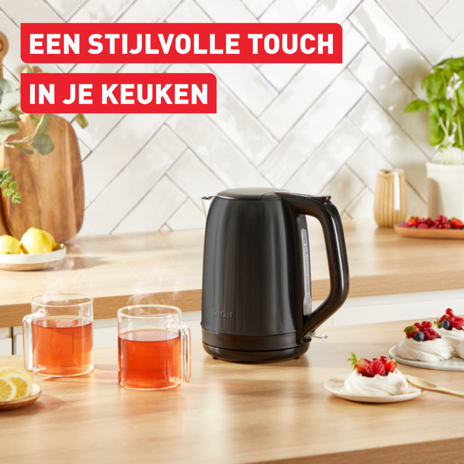 A black kettle is on a wooden counter. Two glasses of tea and desserts are on the counter. Text is above.