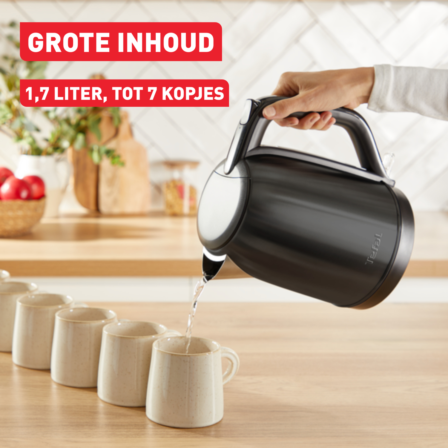 A black kettle pouring water into white mugs on a wooden surface, with text above.