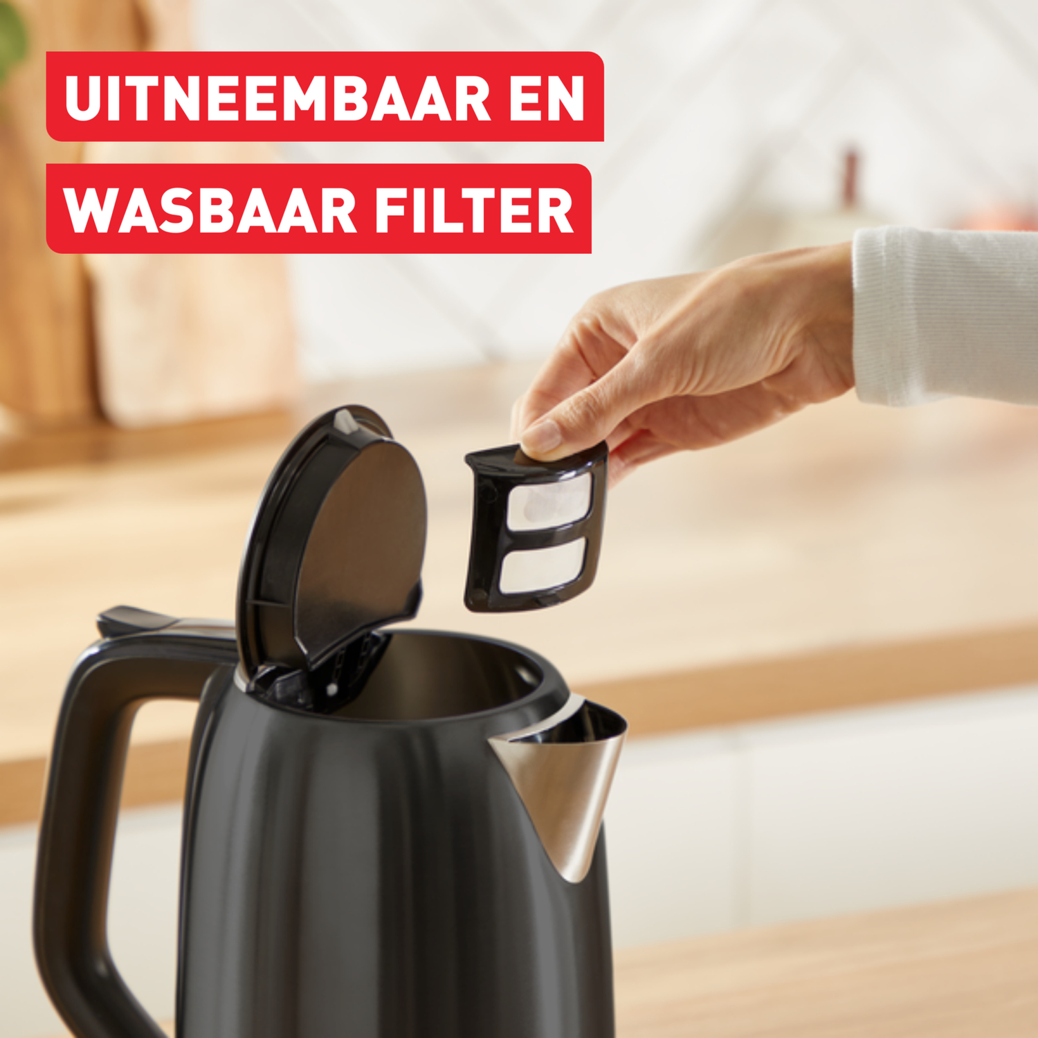 A hand removing a filter from a black kettle, with text about the filter.