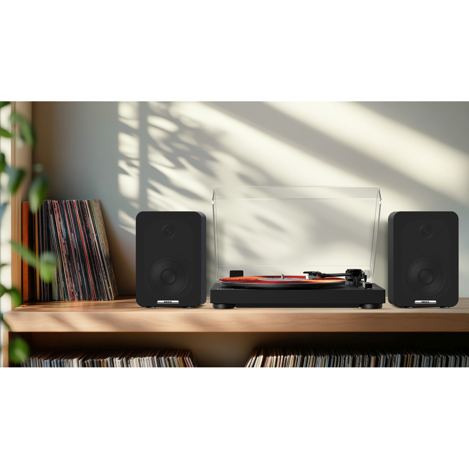 Black turntable with two speakers and records on a wooden shelf.