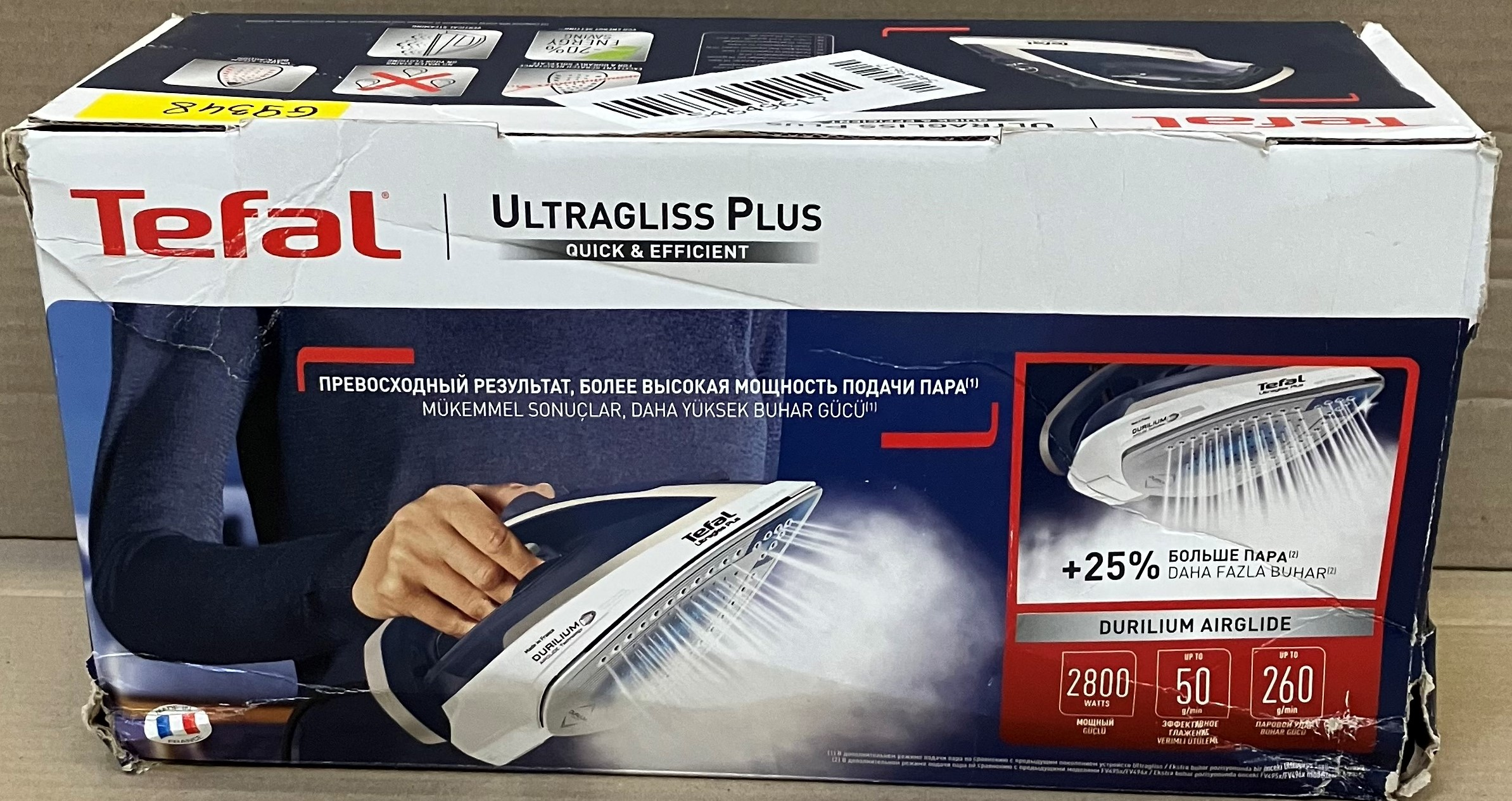Pudełko żelazka Tefal Ultragliss Plus, z widocznym żelazkiem i parą. Tekst w wielu językach.