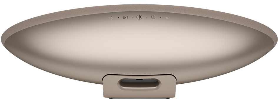 Beżowa, owalna podstawa głośnika z przyciskami i uchwytem.