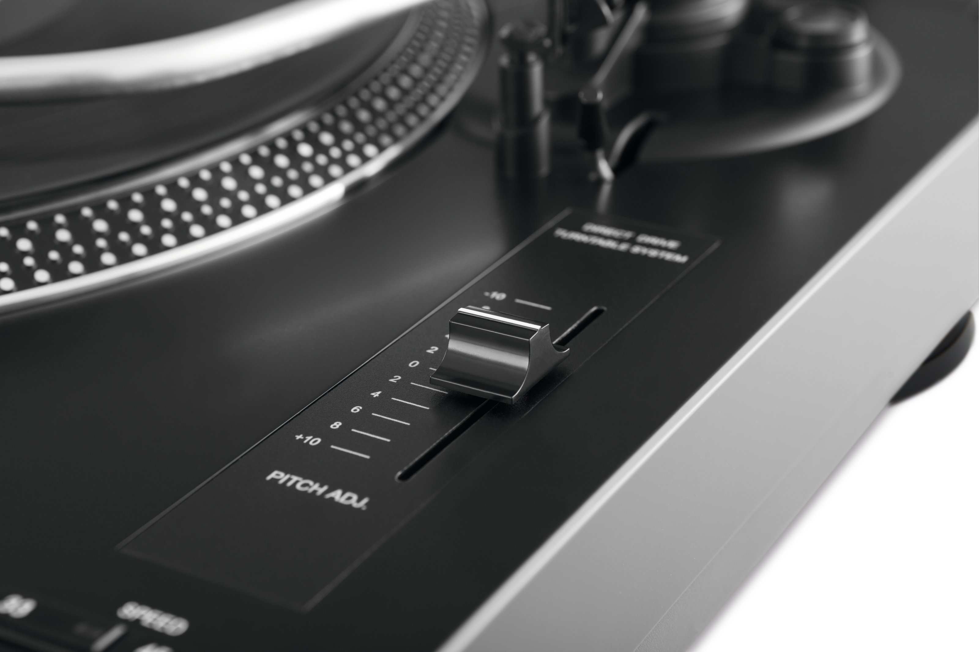 Zbliżenie gramofonu z suwakiem regulacji wysokości dźwięku i wskaźnikami prędkości.