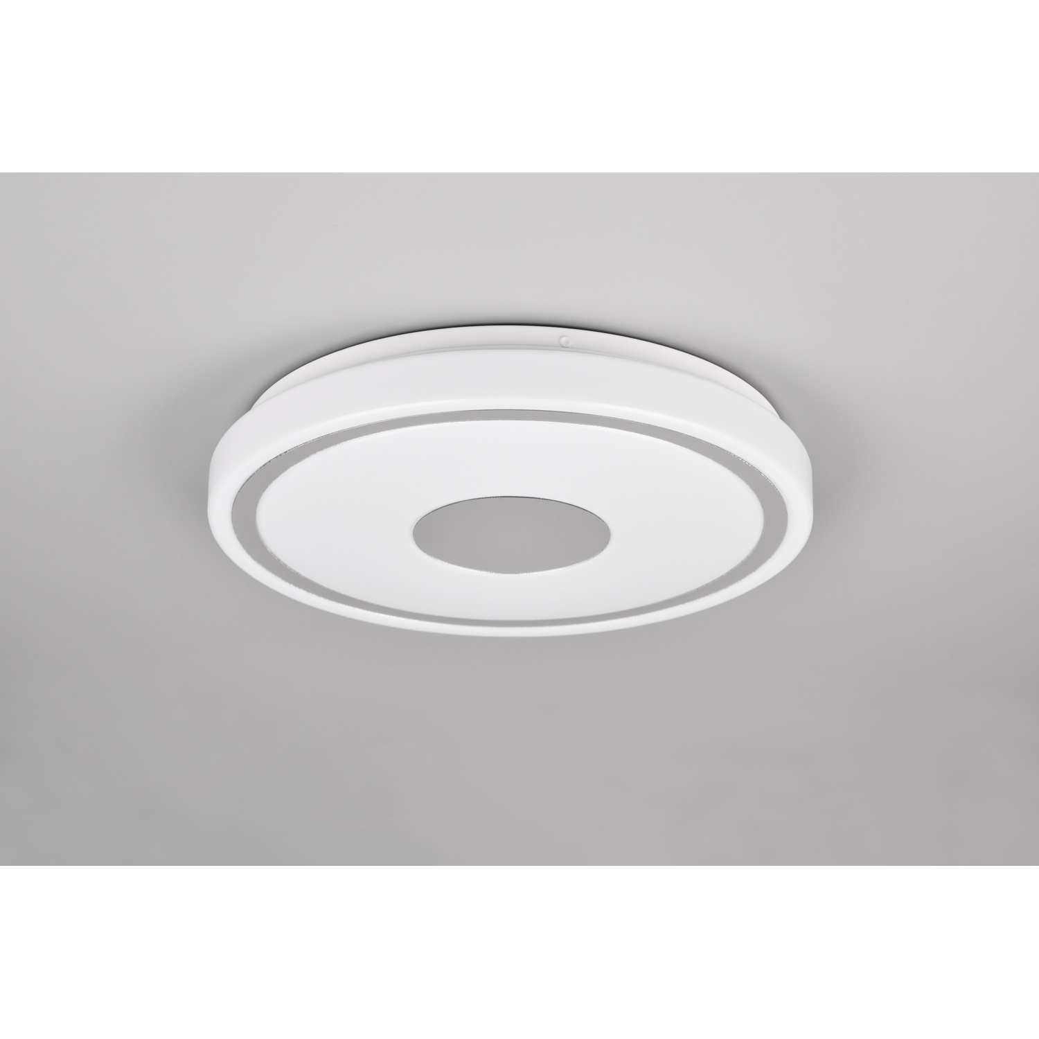 Una plafoniera rotonda bianca con un design circolare e uno sfondo grigio.