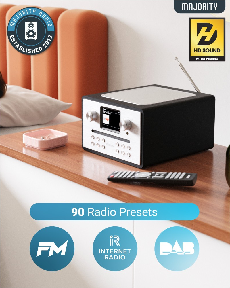 Radio noir et blanc sur une surface en bois. Affiche un écran et des boutons.