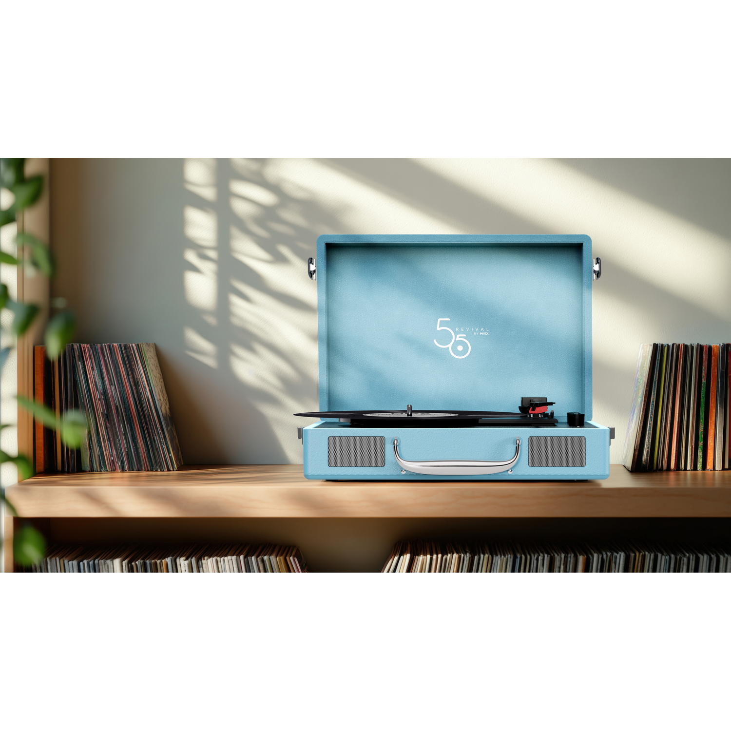 Record player with open lid, a blue vinyl plays, books on a shelf in the background.