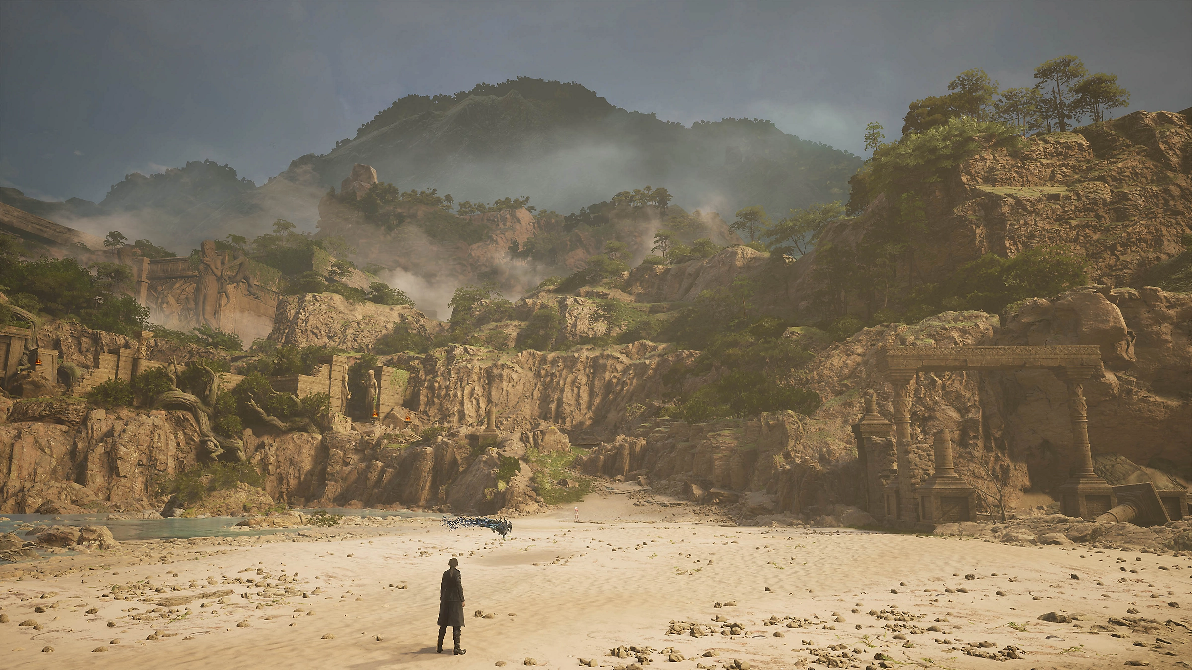 Malowniczy krajobraz z osobą, górami i starożytnymi budowlami.