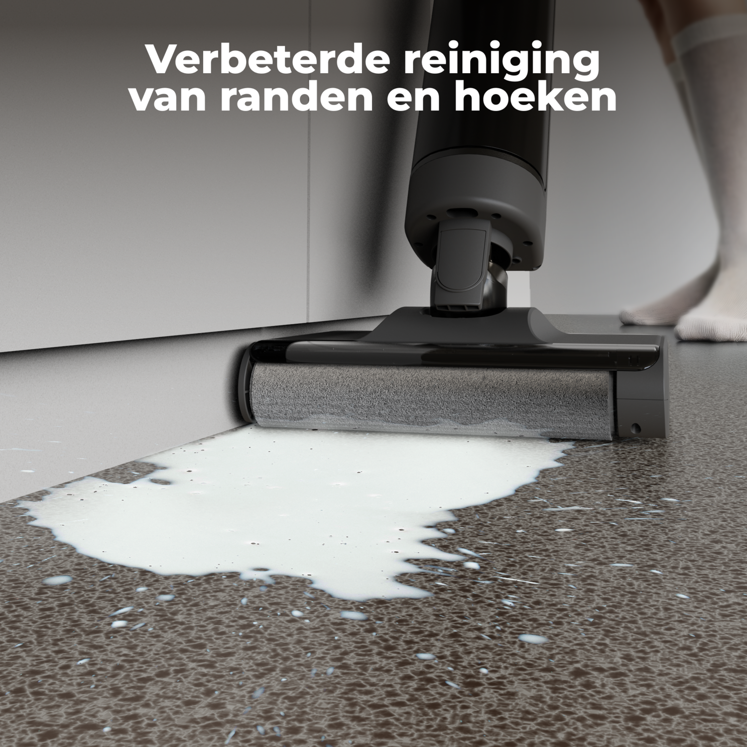 A white liquid spill on a floor being cleaned by a grey cleaning device.
