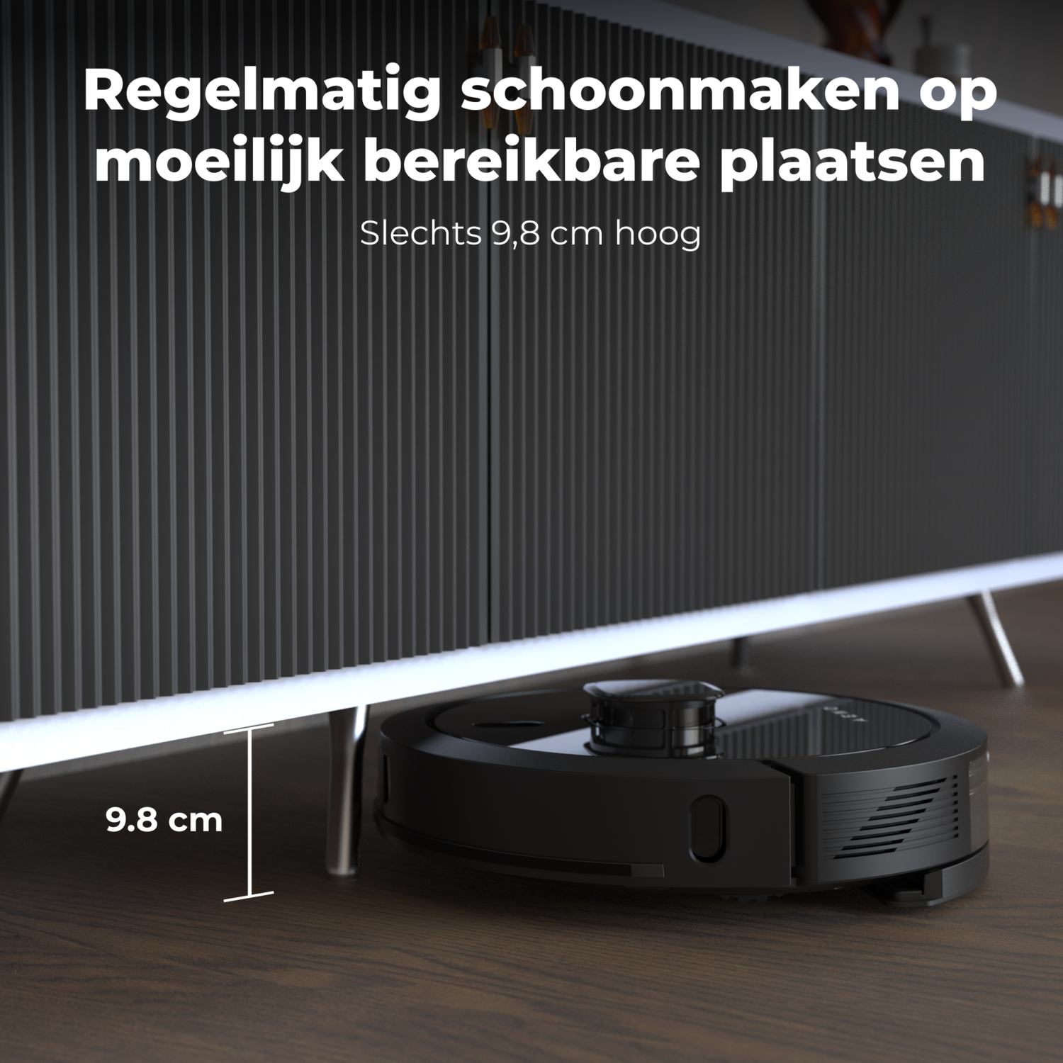 A black robotic vacuum cleaner under a cabinet. The cabinet has wooden legs and a dark surface.
