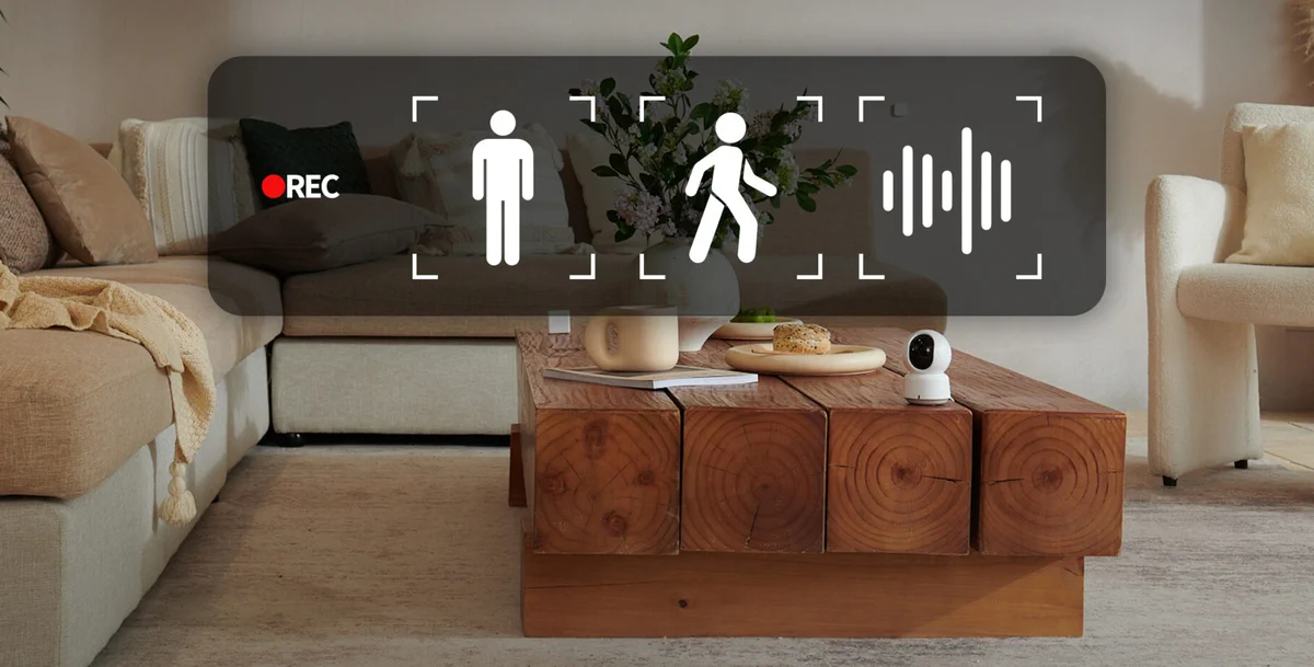 Scena w salonie z nałożonymi ikonami kamery. Zawiera ikony osoby, chodzenia i dźwięku.