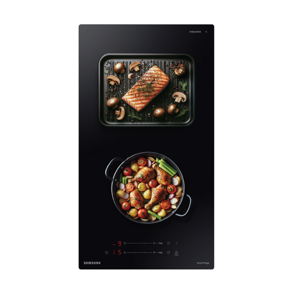 Placa de inducción negra con comida. Se muestran salmón y pollo con verduras.