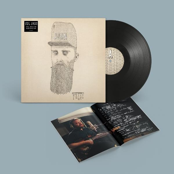 Album borító. Egy szakállas, kalapos férfi rajza. Vinyl lemez a tetején.