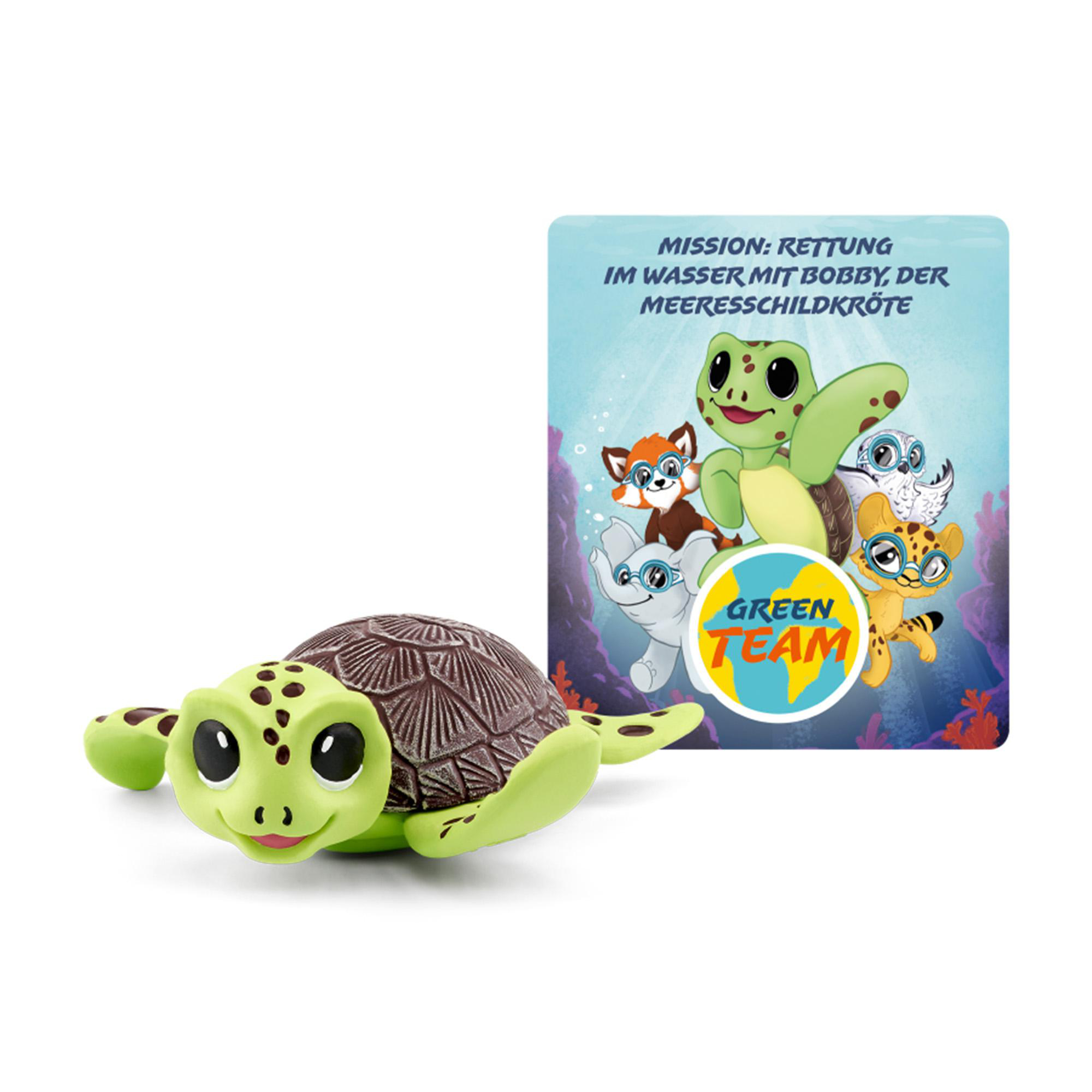 Ein grünes Schildkrötenspielzeug mit einer Green Team Karte. Die Karte zeigt Zeichentricktiere um eine Schildkröte.