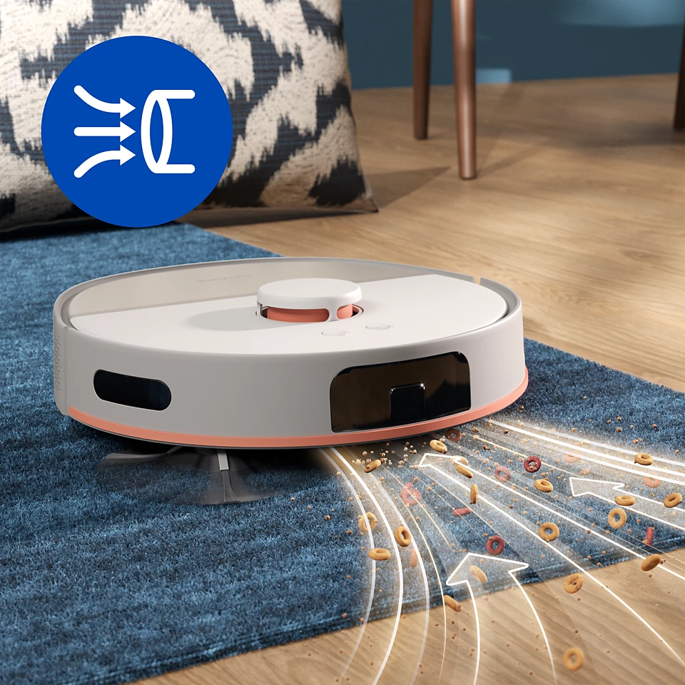 Robot porszívó tisztít nyíl ikonokkal, egy kék szőnyegen szétszórt gabonafélékkel.