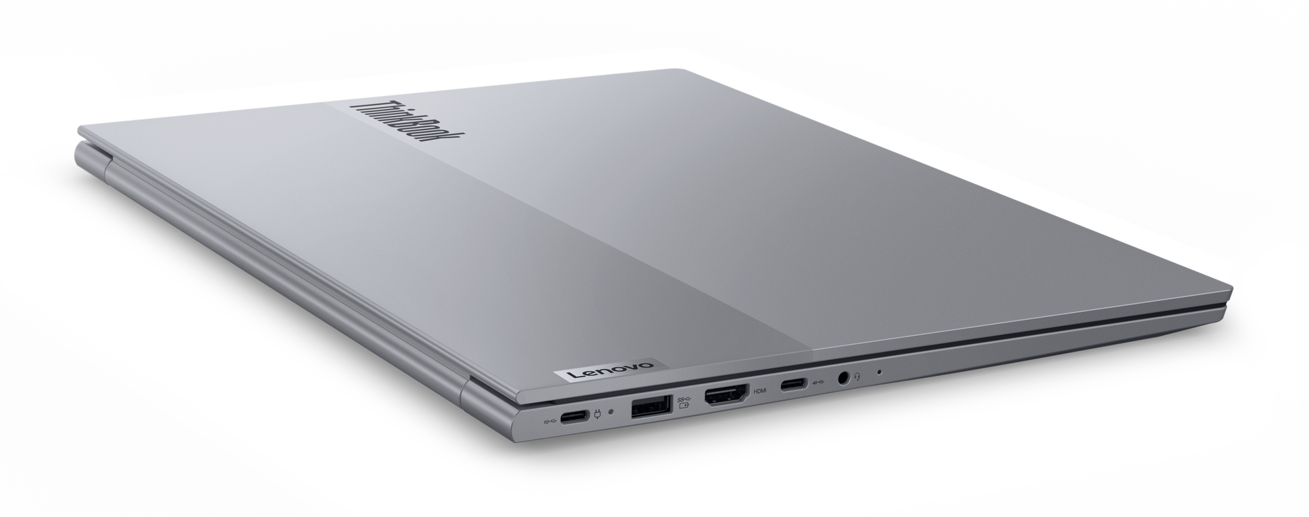 Srebrny laptop Lenovo ThinkBook na czarnym tle, lekko pochylony.