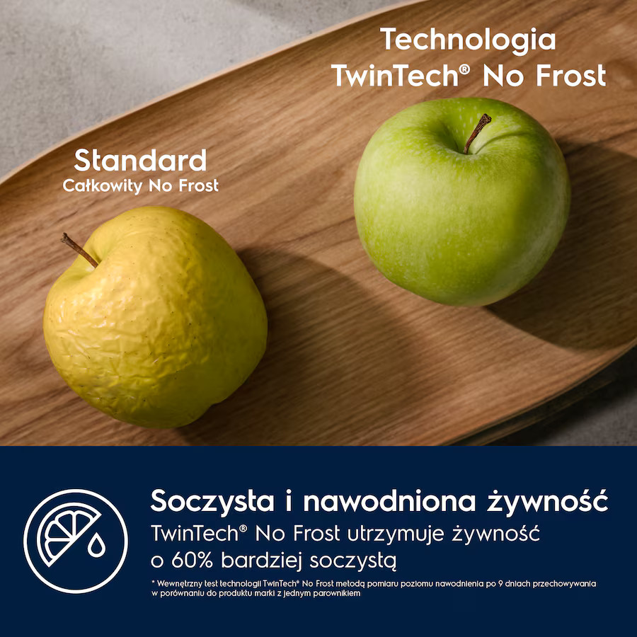 Drewniana taca z żółtym jabłkiem i zielonym jabłkiem. Tekst: TwinTech® No Frost i deklaracja świeżości.