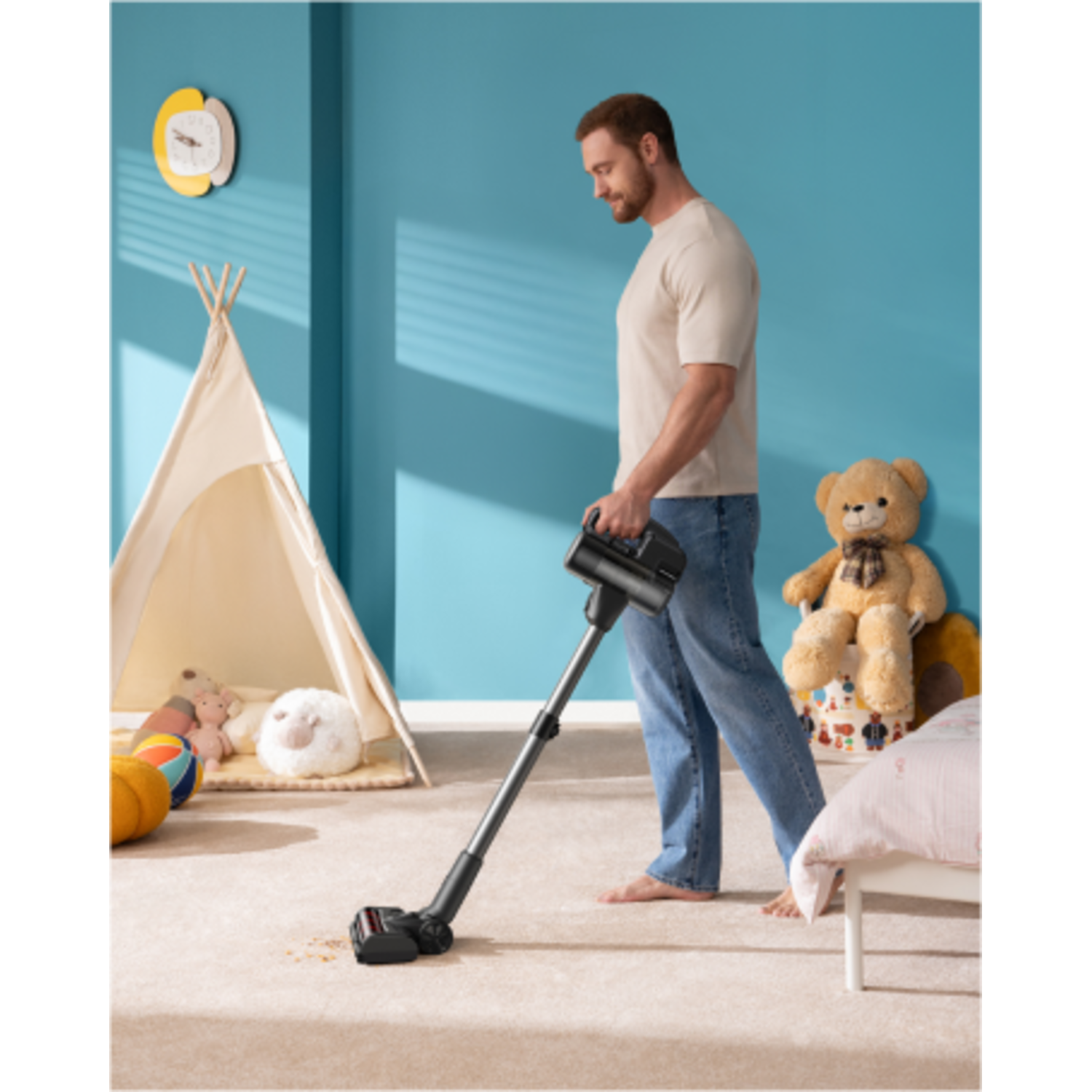 A man vacuuming a carpeted floor in a child's room.