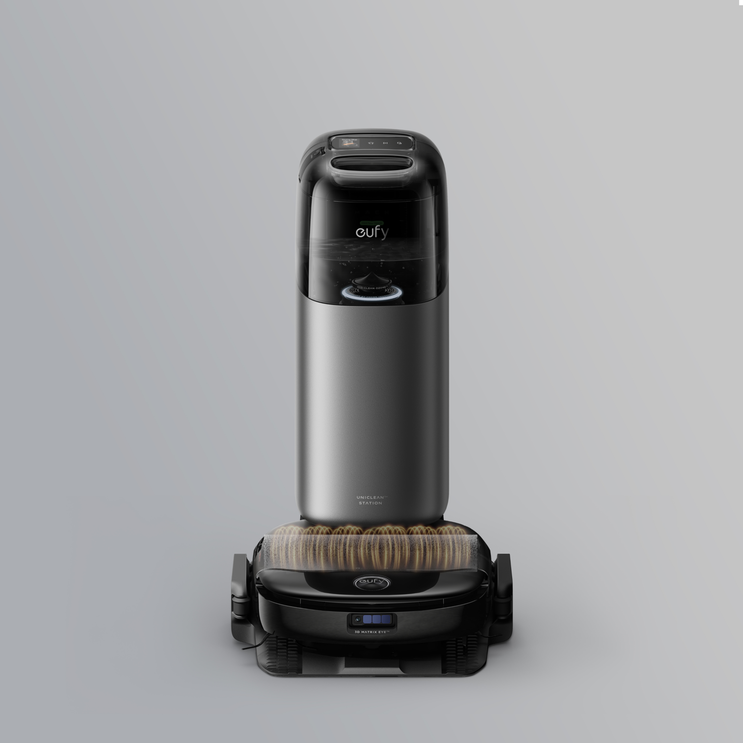 Un aspirateur robot Eufy noir et argent, vertical, sur fond gris.