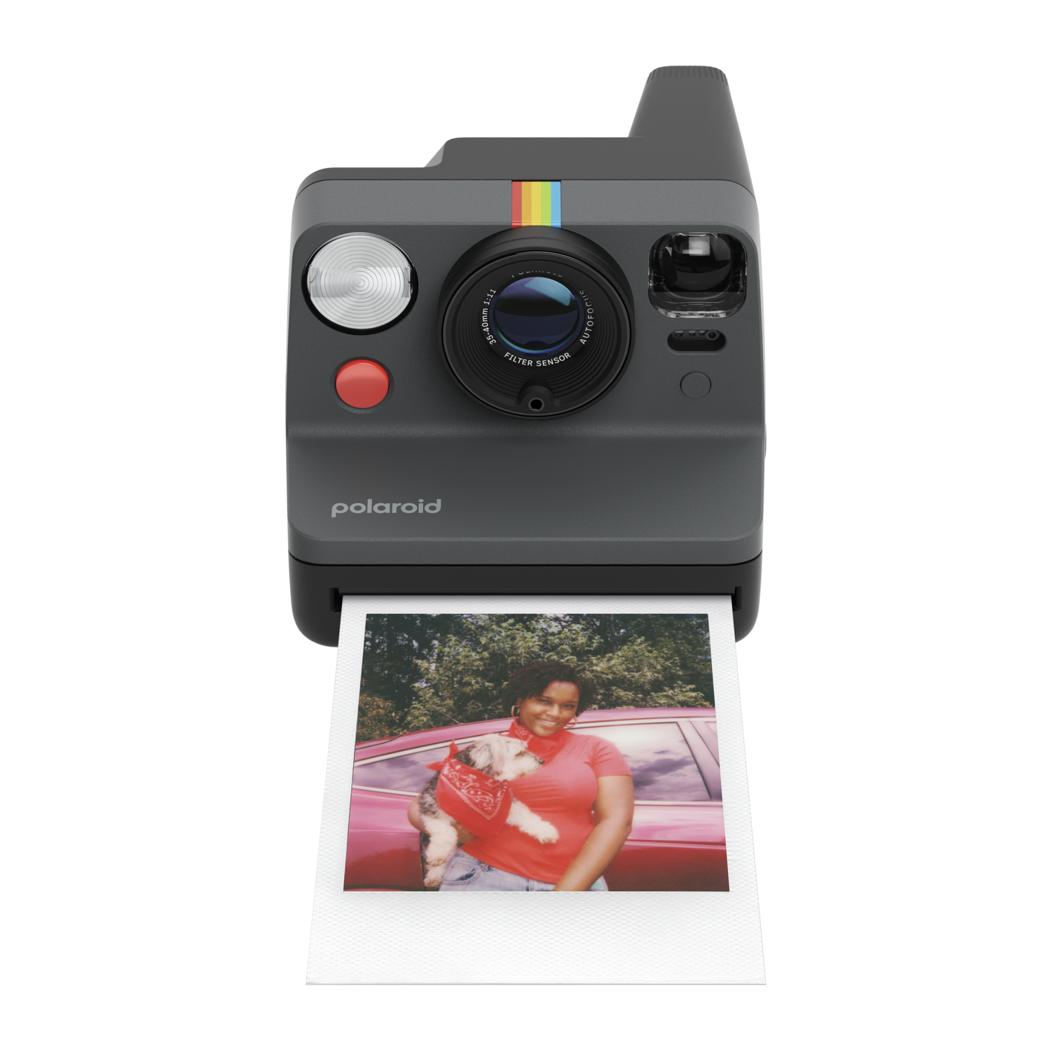 Polaroid camera with a picture of a woman holding a dog, printed on a photo.