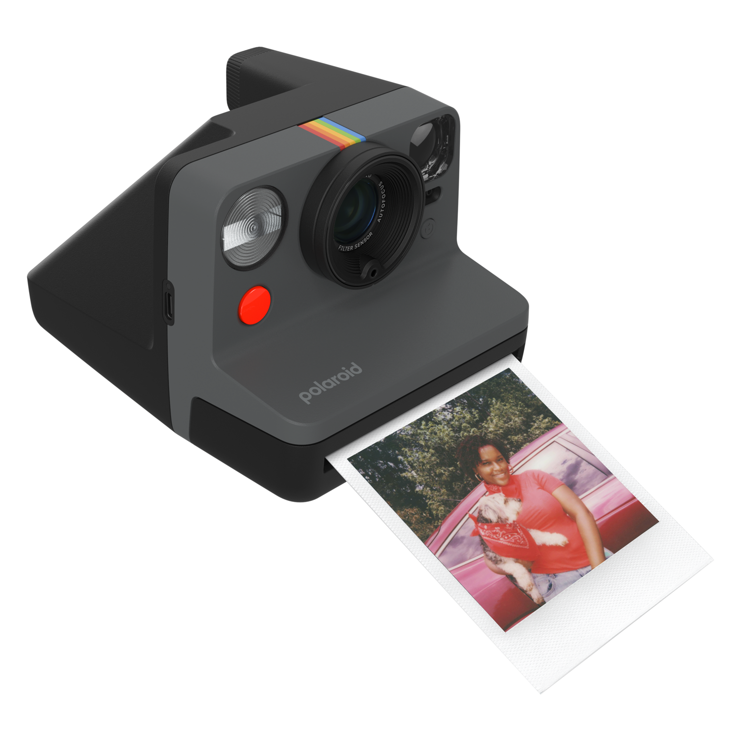 Polaroid camera with photo being ejected, person in background.