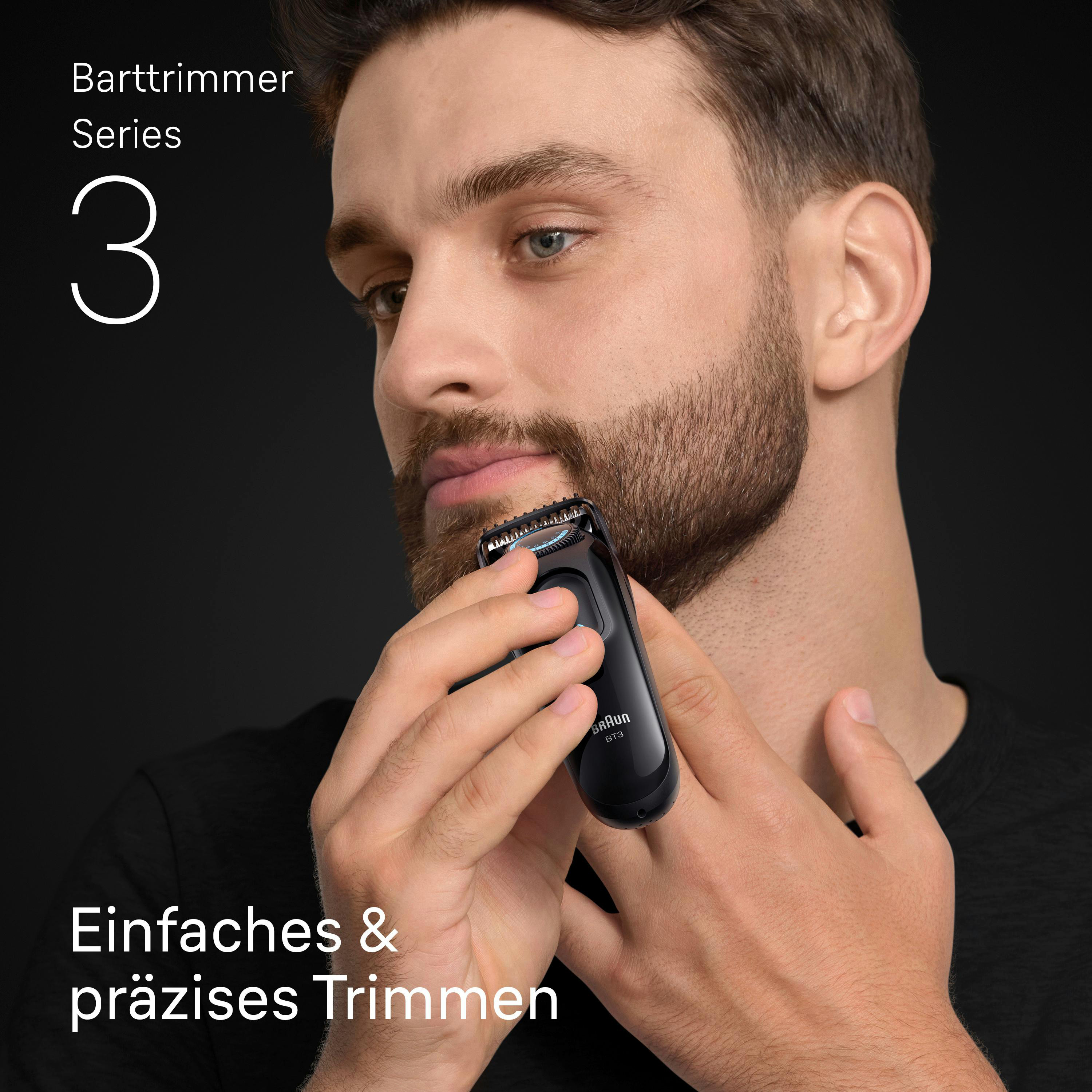 Mann benutzt einen schwarzen Barttrimmer. 'Braun'-Logo sichtbar. Detailierter Schnitt.
