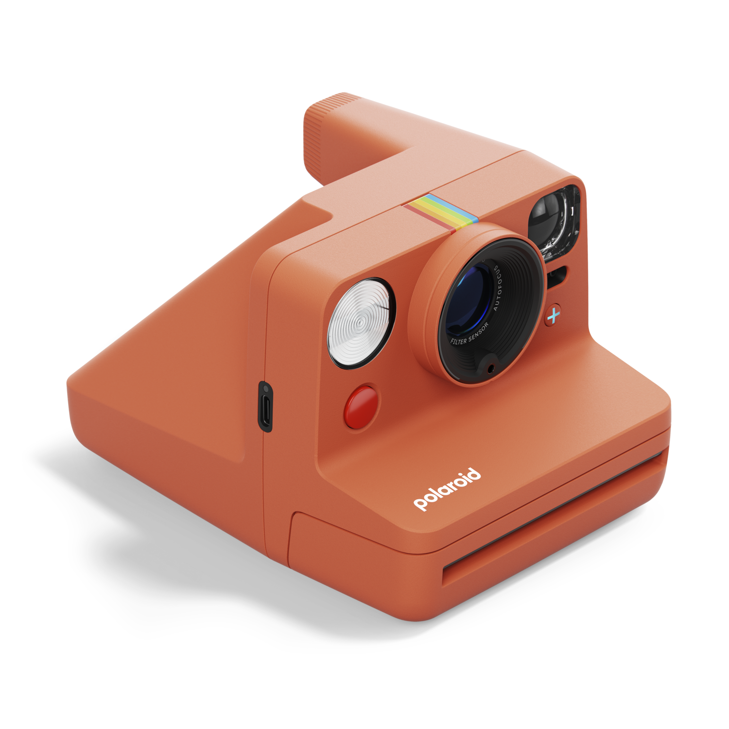 Appareil photo Polaroid orange sur une surface noire. L'appareil a une bande arc-en-ciel.