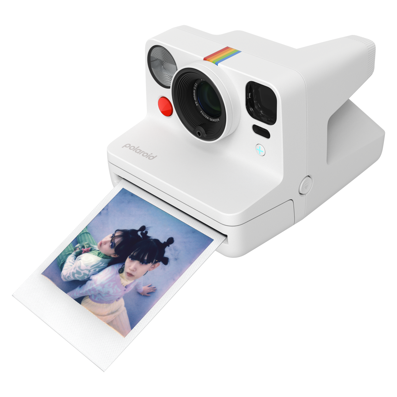 White Polaroid camera printing a photo of two girls. The camera has a rainbow stripe.
