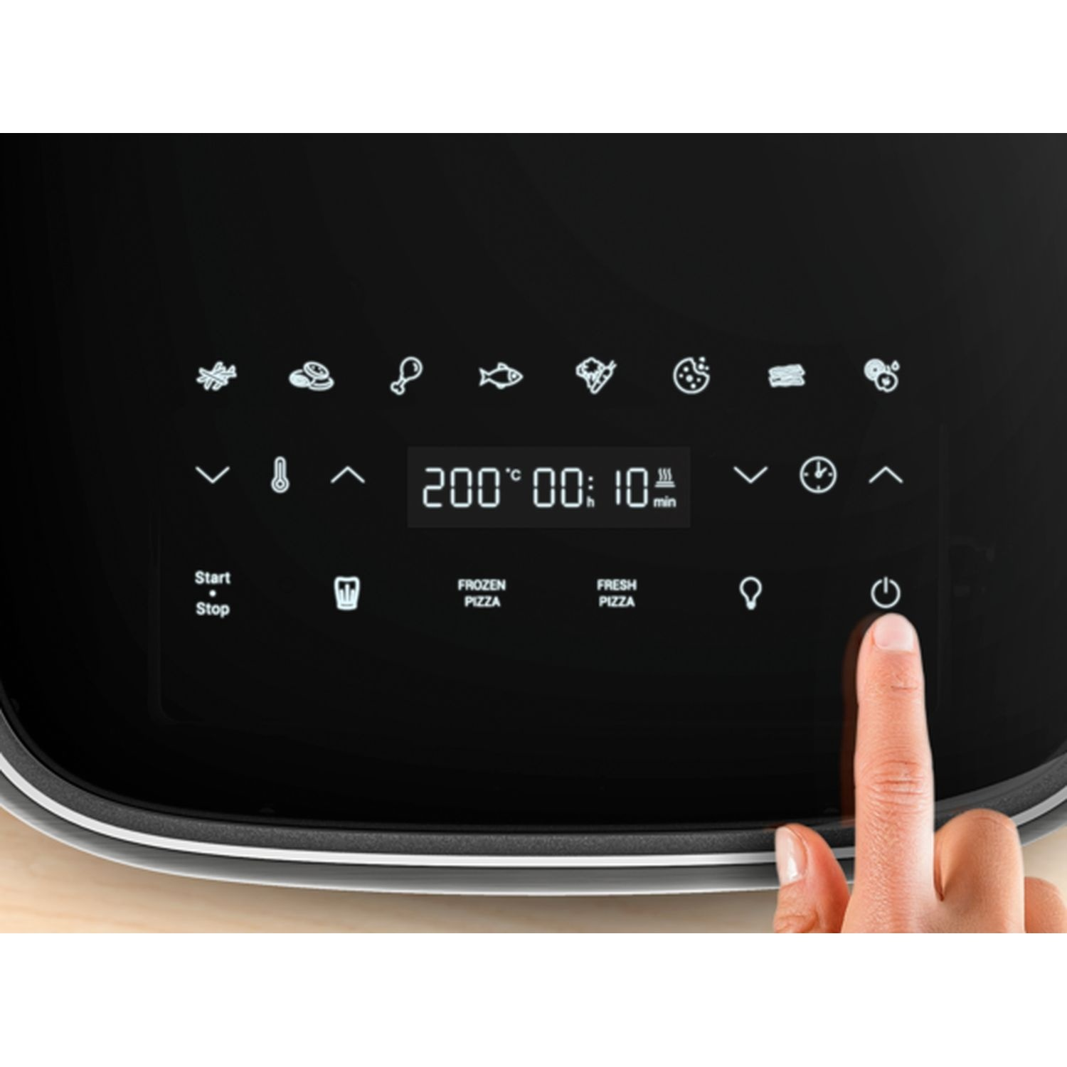 A hand presses a power button on a black air fryer control panel, displaying settings for temperature and cooking time.
