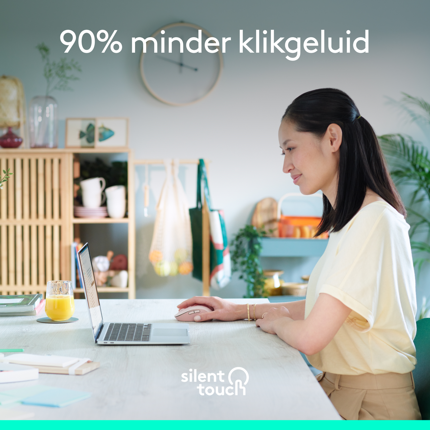 Woman using a laptop. Text reads: "90% less click sound". Wooden cabinet in the background.