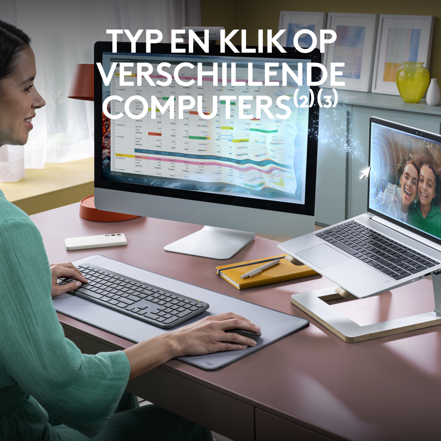 A woman uses a keyboard and mouse with a desktop and laptop.
