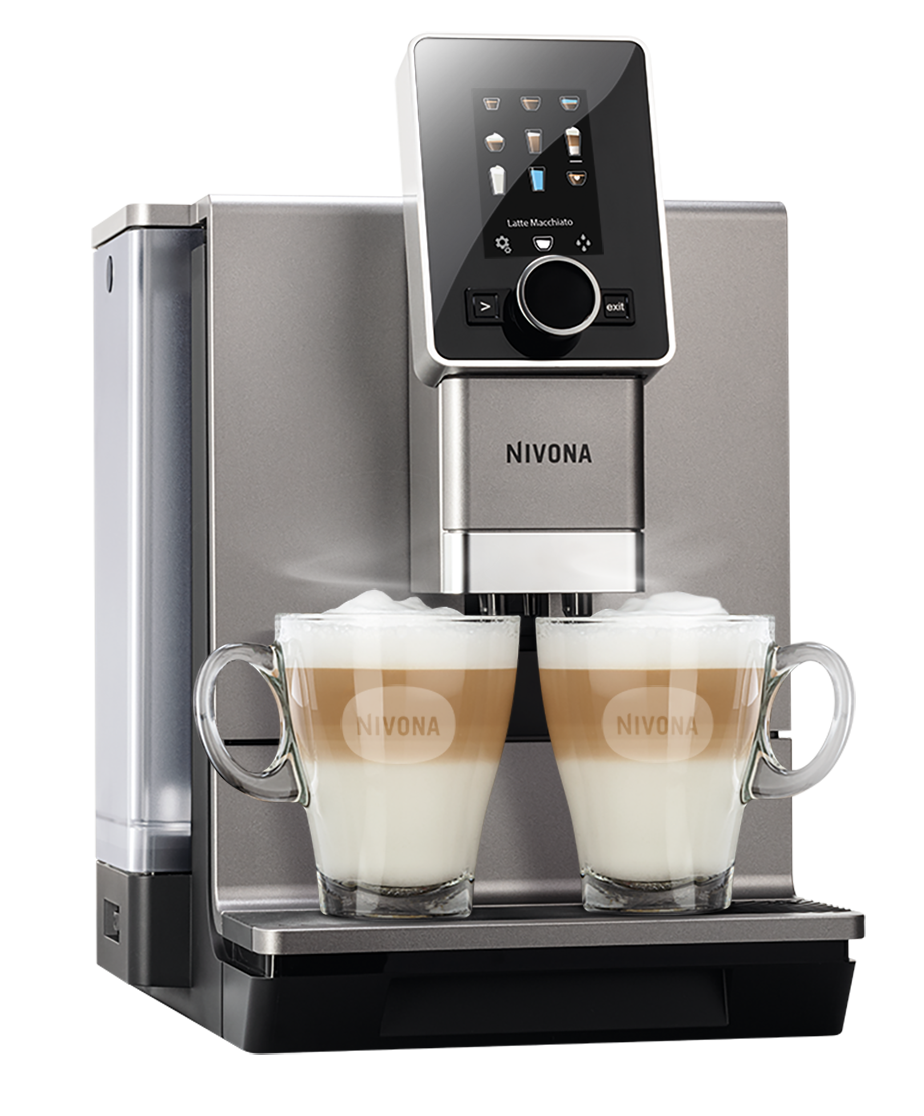 Ekspres do kawy z dwiema filiżankami latte macchiato. Przezroczyste szklanki. Czarne tło.