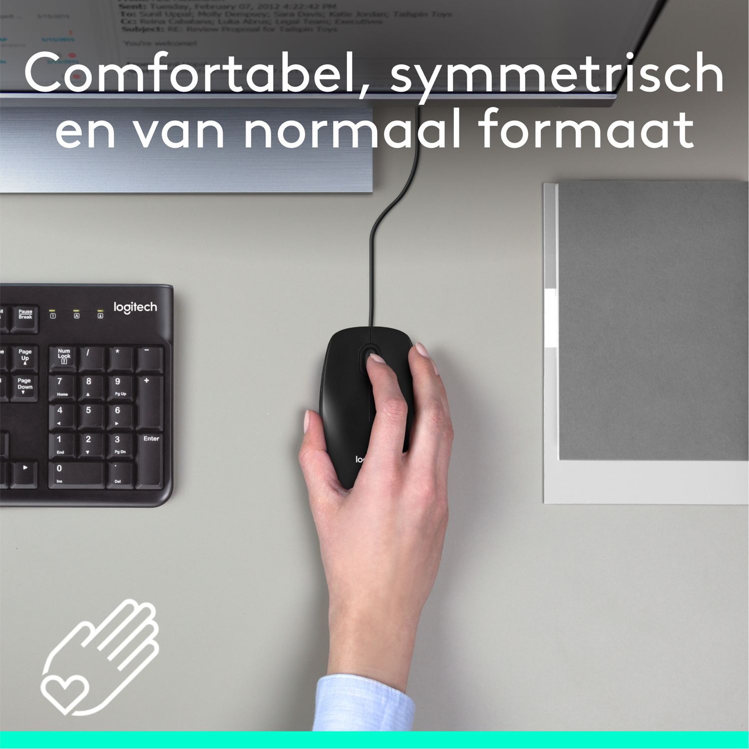 A person's hand on a black computer mouse next to a black keyboard and a paper.