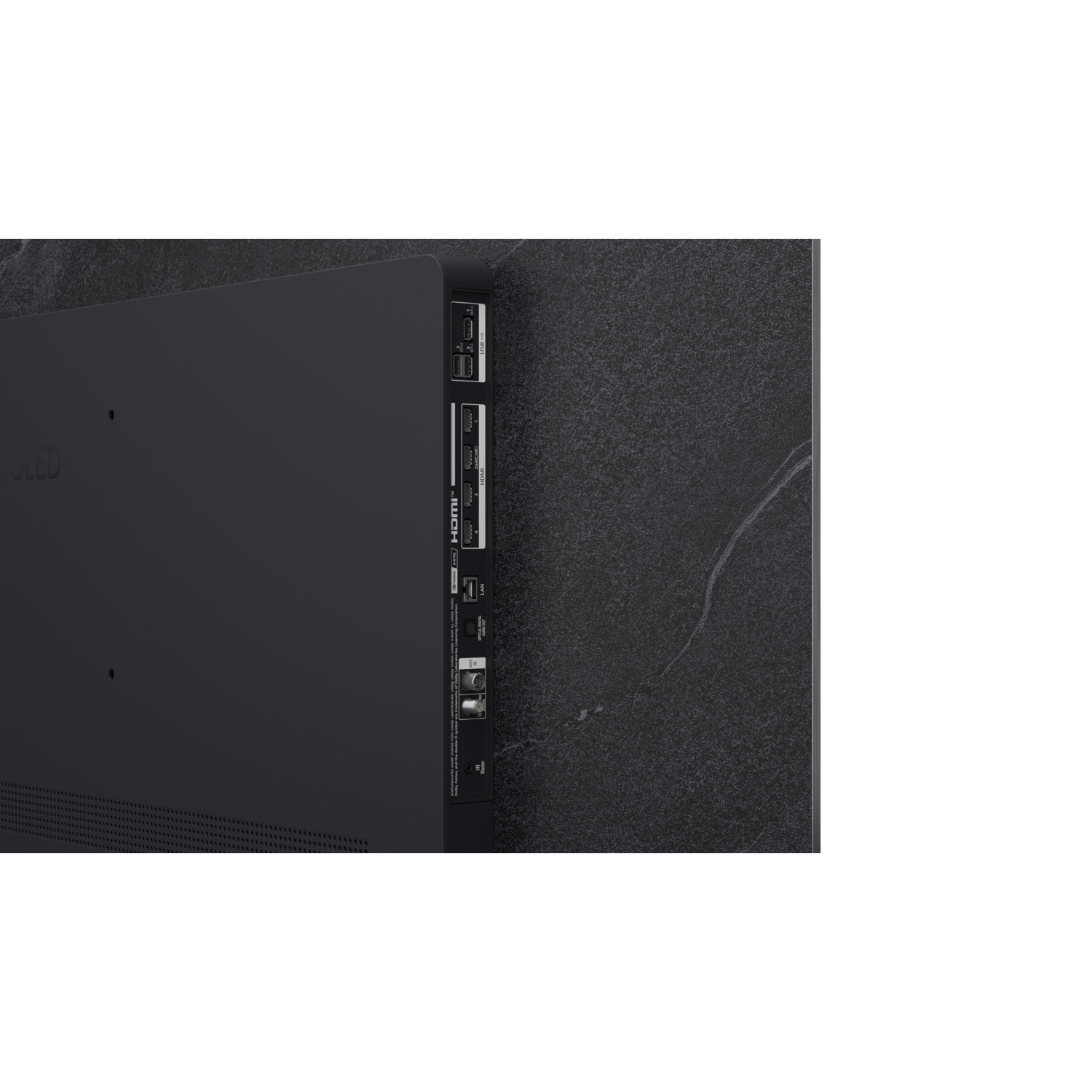 Gros plan de l'arrière d'un téléviseur noir, montrant ports et connecteurs sur fond gris foncé.