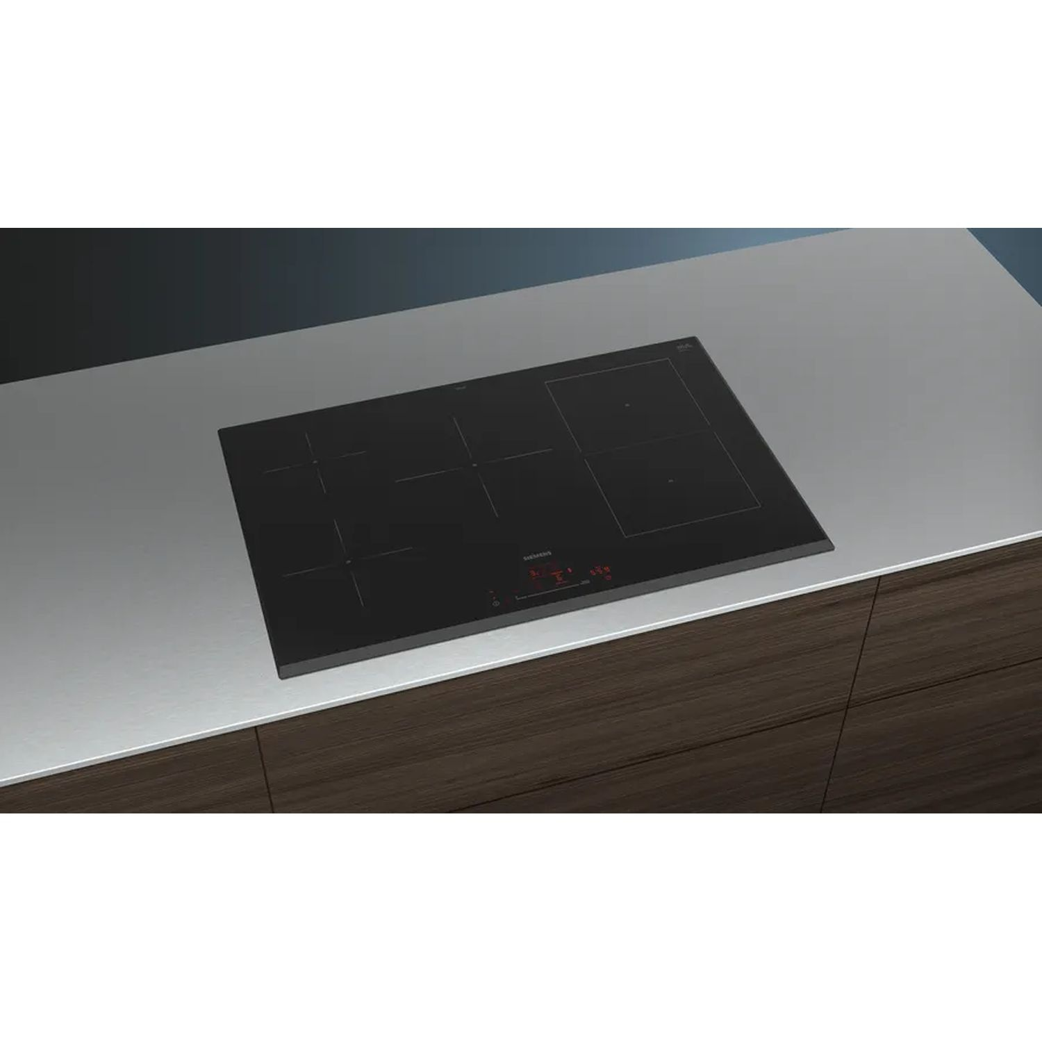 Black induction cooktop on a metal surface and dark wood cabinet. Controls are visible.
