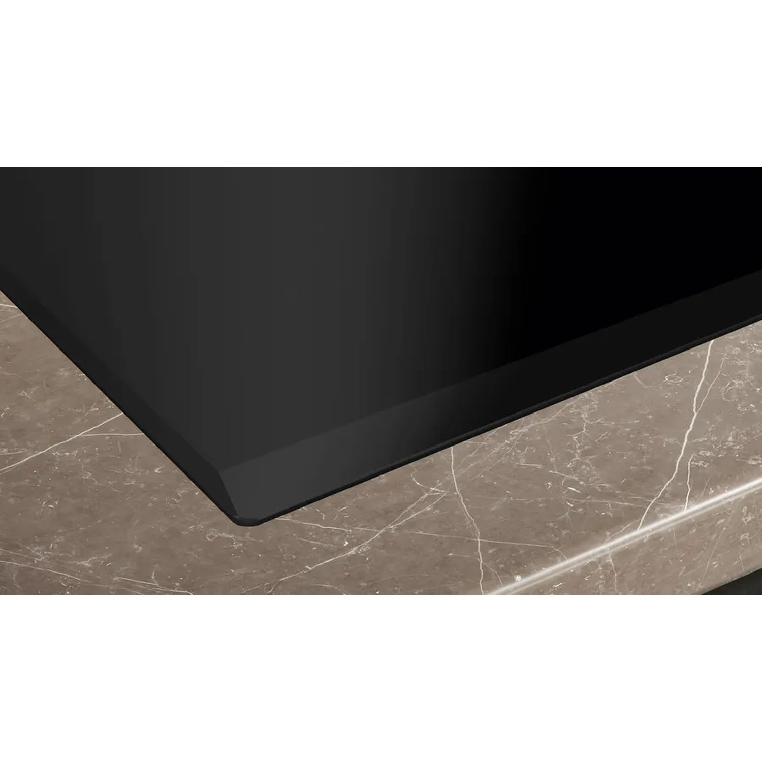 Black stovetop on a marble counter. The edge is black.
