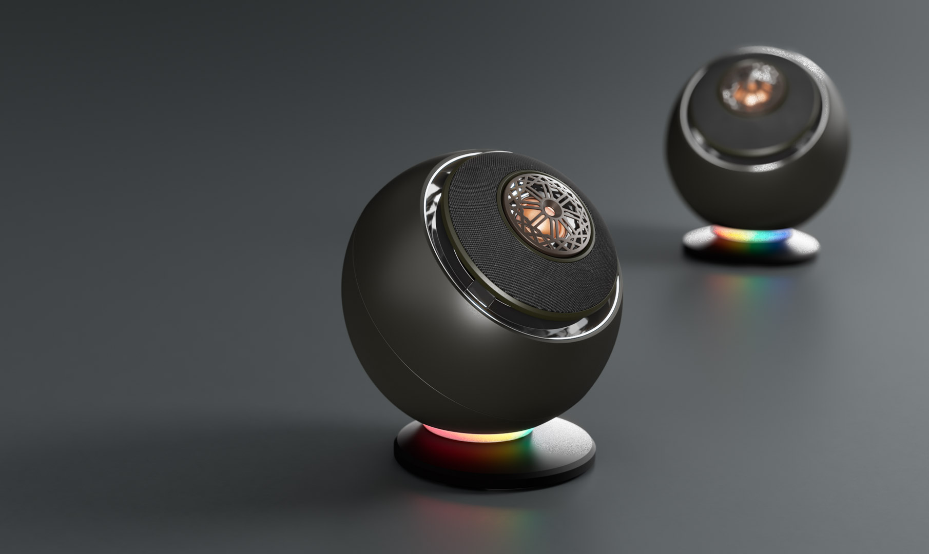 Dwa czarne głośniki na ciemnoszarym tle, ze światłami tęczowymi.