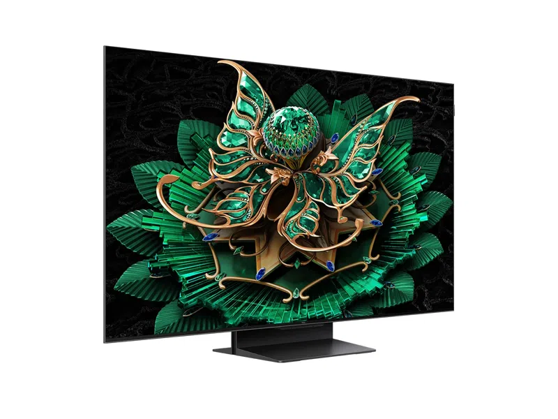 Ein moderner Fernseher, der ein kompliziertes Blumendesign auf schwarzem Hintergrund zeigt, Seitenansicht.