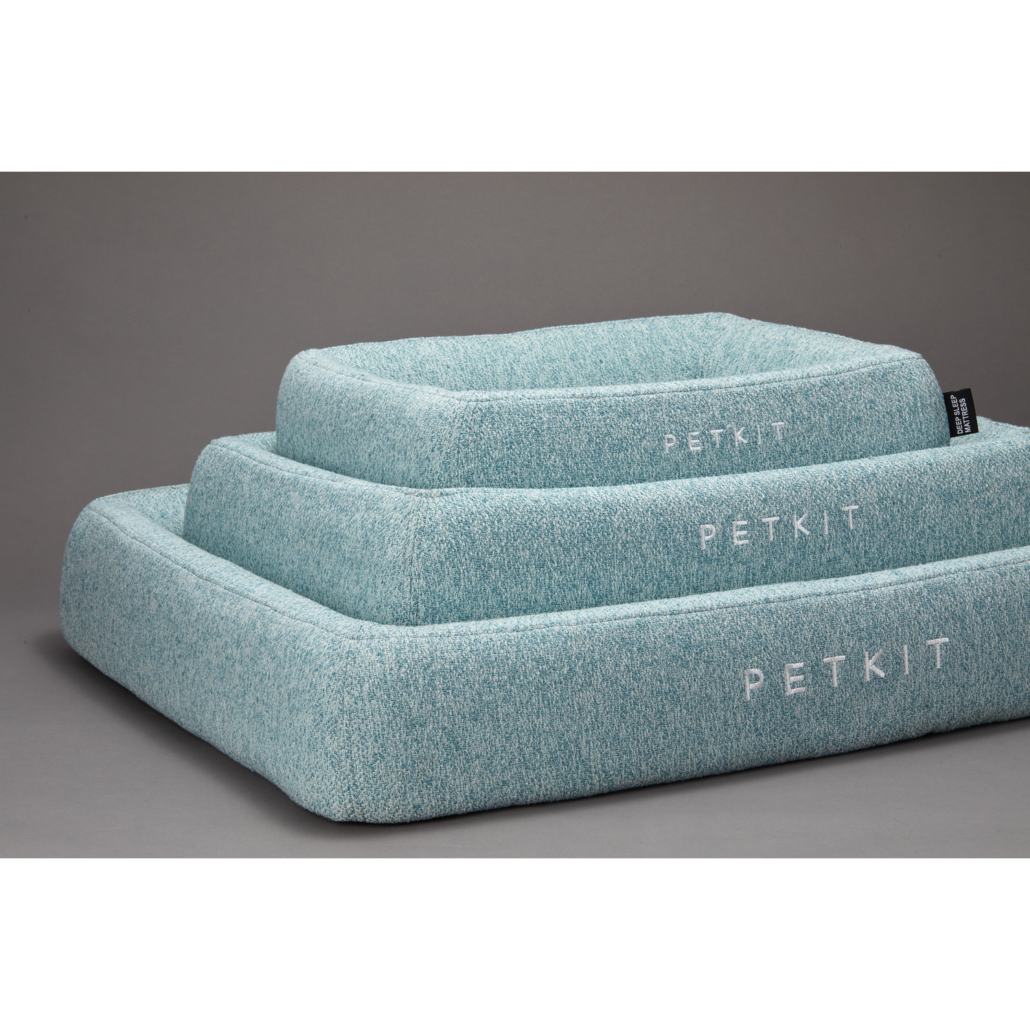 Three light blue pet beds stacked, with the word PETKIT written on each.