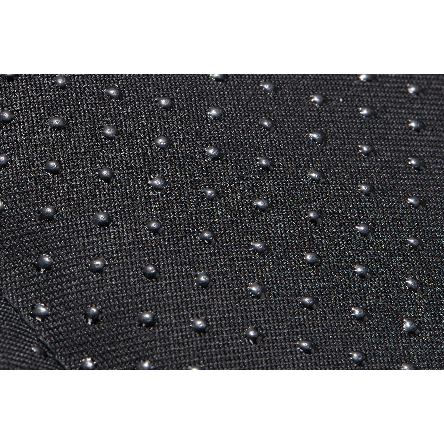 Close-up of a black fabric with many small, evenly spaced, gray, spherical bumps.