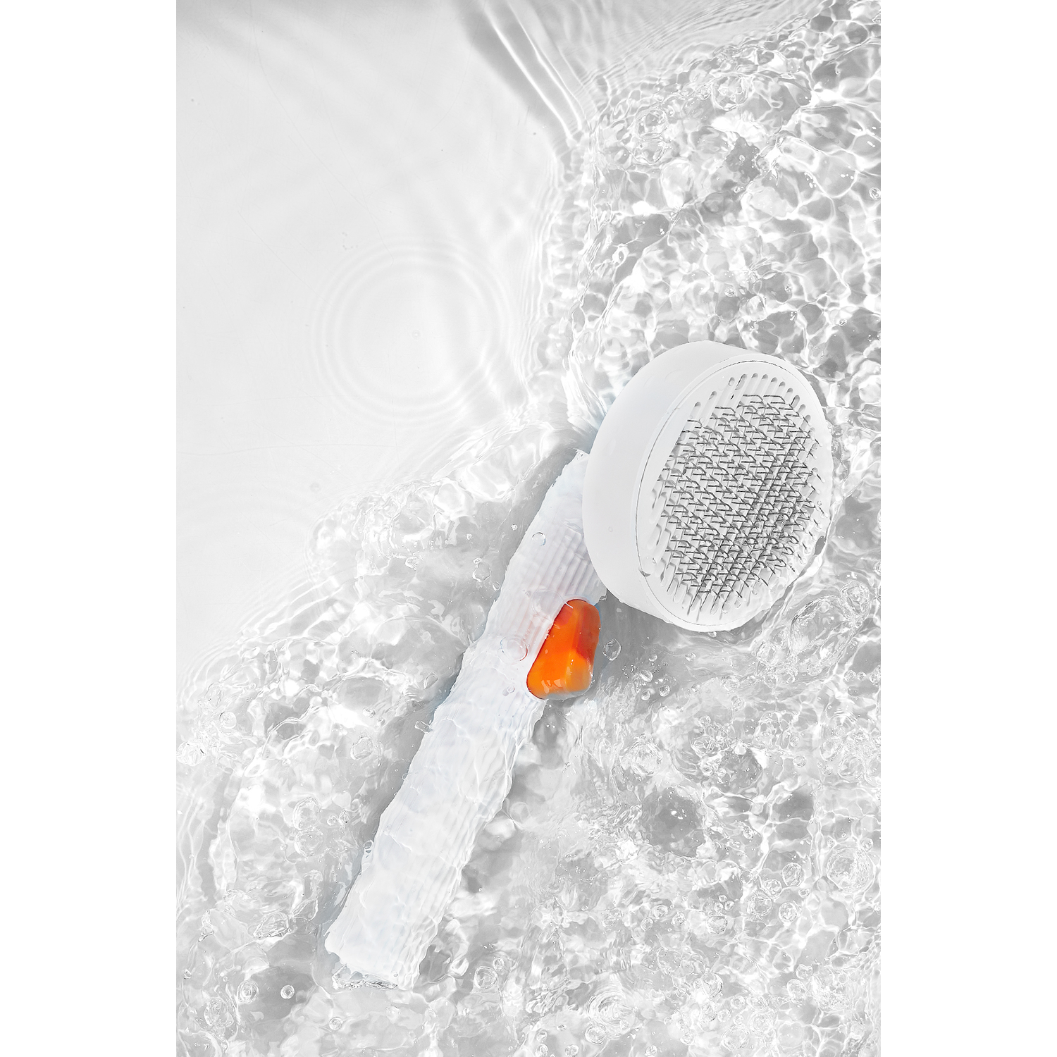 White shower head with water flowing around it. Orange accent on the handle.