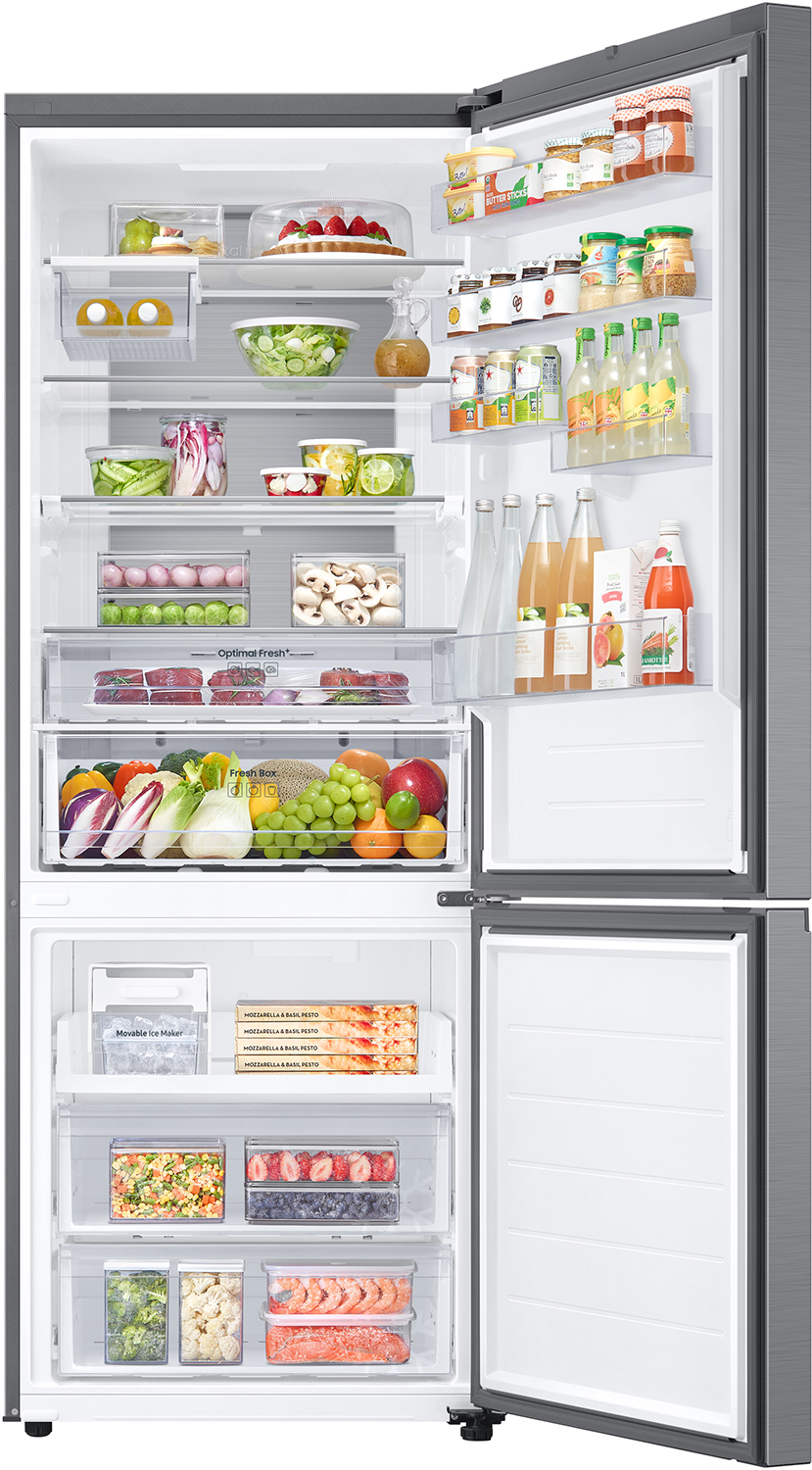 An open refrigerator filled with various food items on shelves and in drawers. Includes fruits, vegetables, and drinks.
