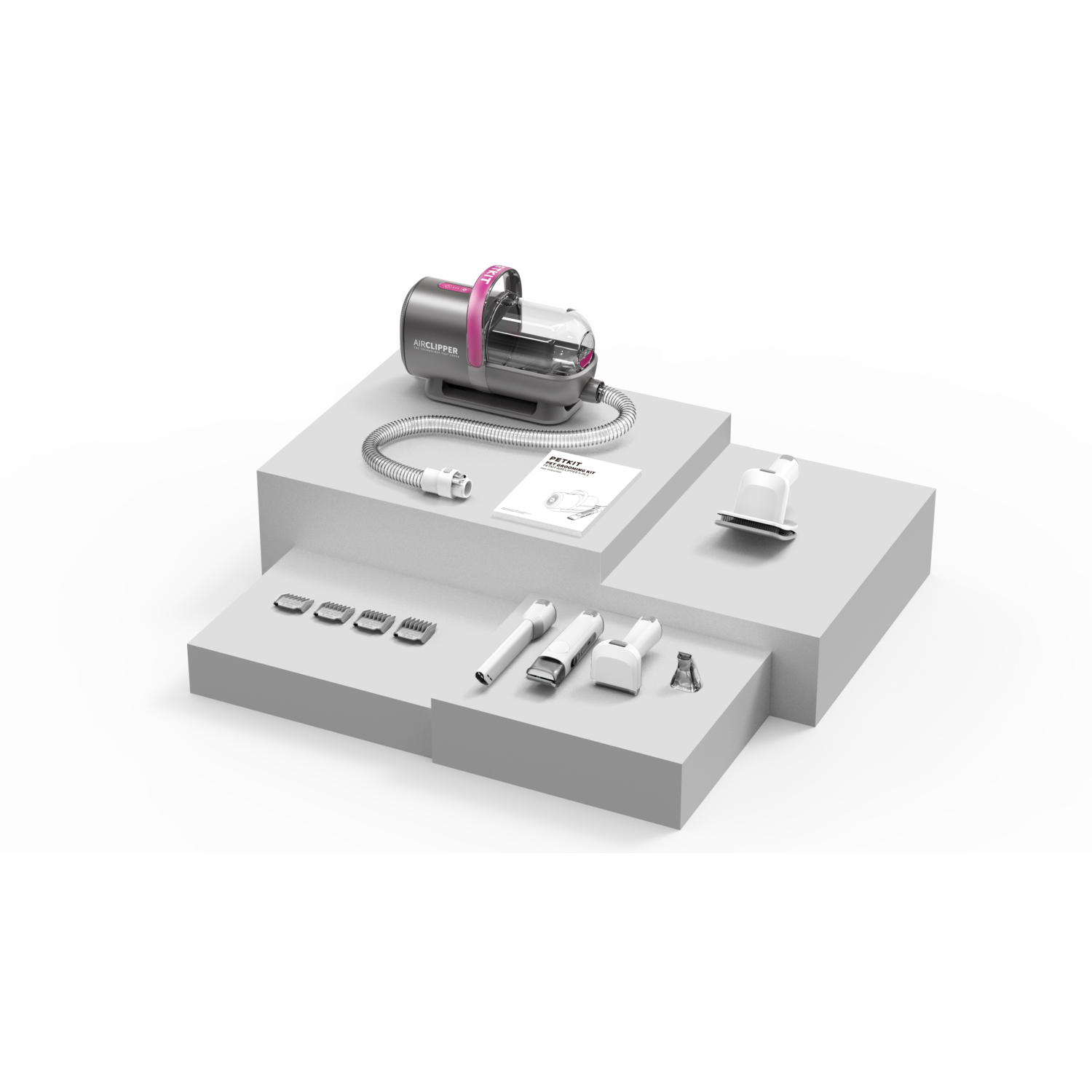 A pet grooming kit with a pump, accessories, and a manual are arranged on white platforms.