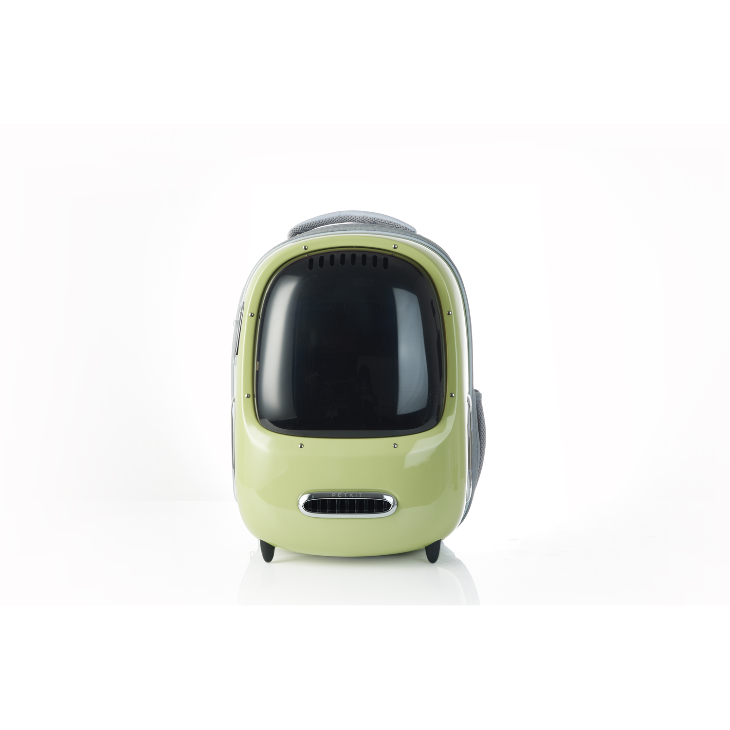 A green and black pet carrier backpack on a white surface.