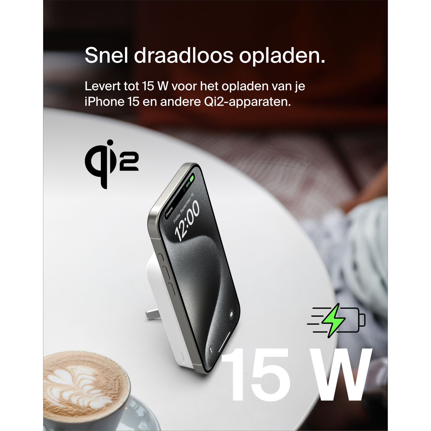 White wireless charger with a phone displaying time, and coffee cup.