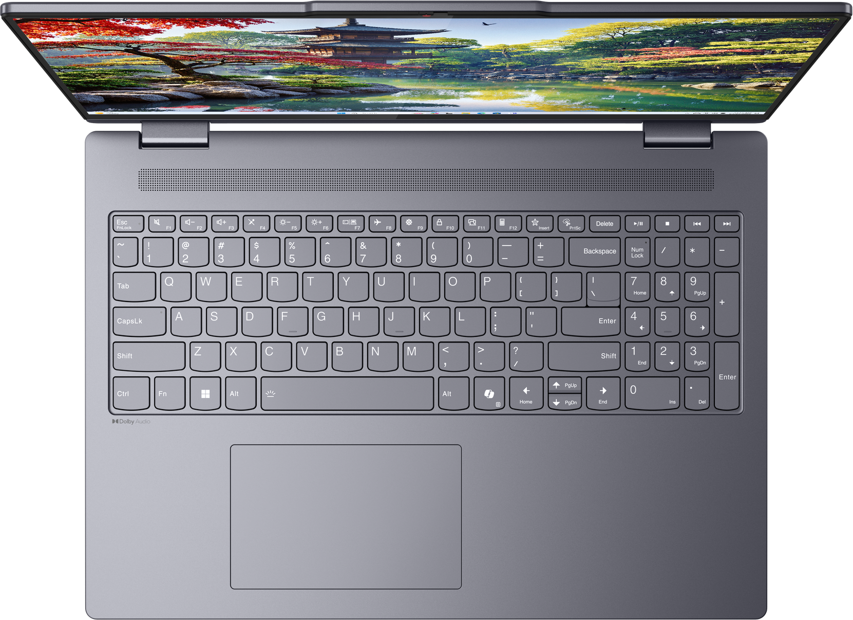 Laptop dall'alto, aperto. Tastiera in primo piano. Il display mostra un paesaggio colorato.