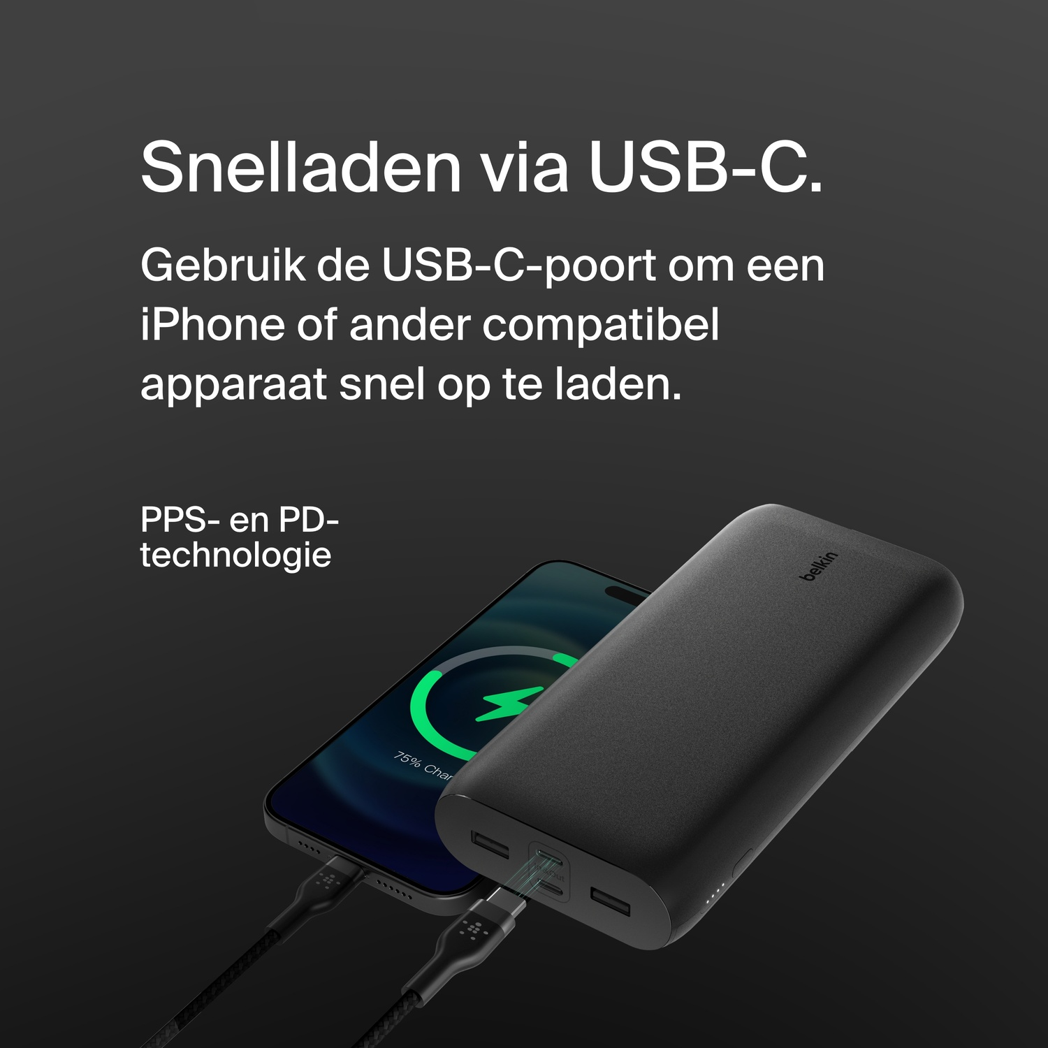 Black power bank charging a phone via USB-C cable, on a black surface.