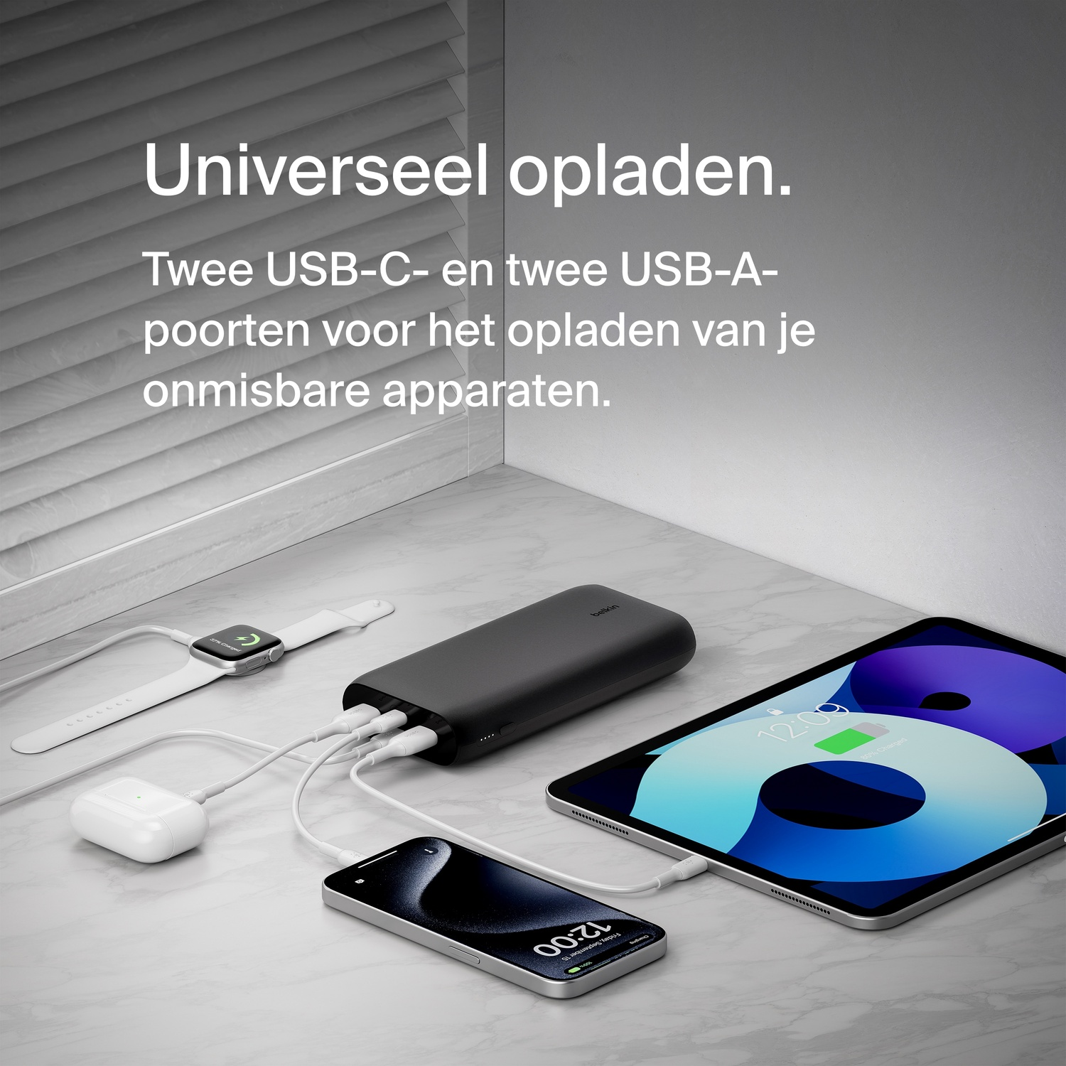 Multiple devices charging from a black power bank. Devices include a watch, earbuds, phone, and tablet.