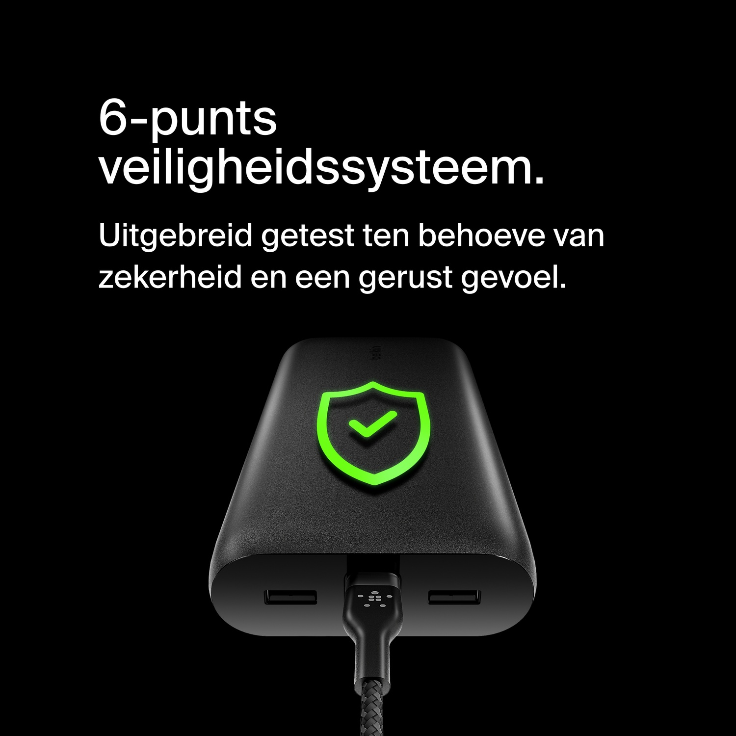 A black power bank with a green shield icon and a cable plugged in.