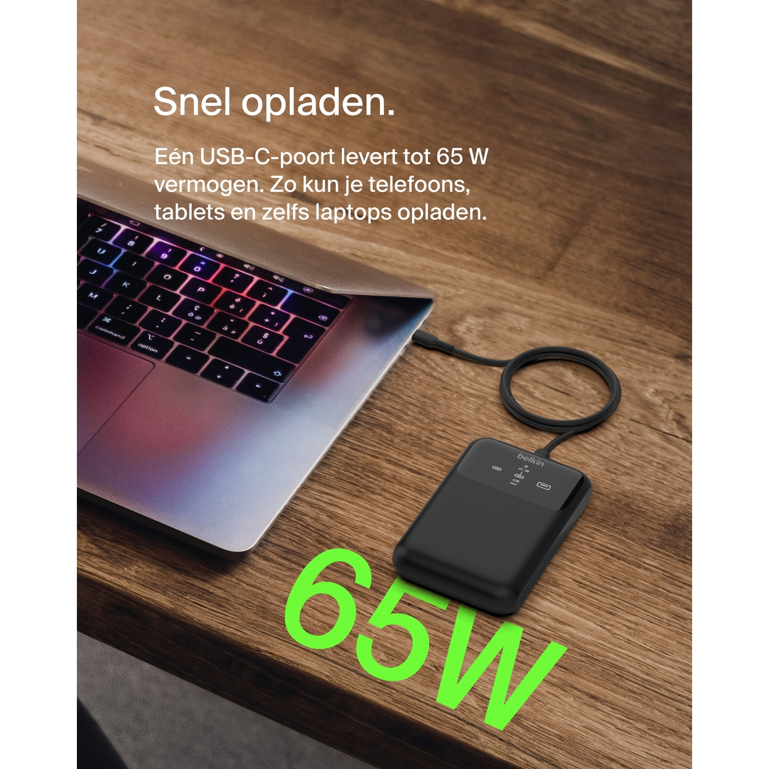 Laptop connected to a black power bank with 65W output. Text reads '65W'.