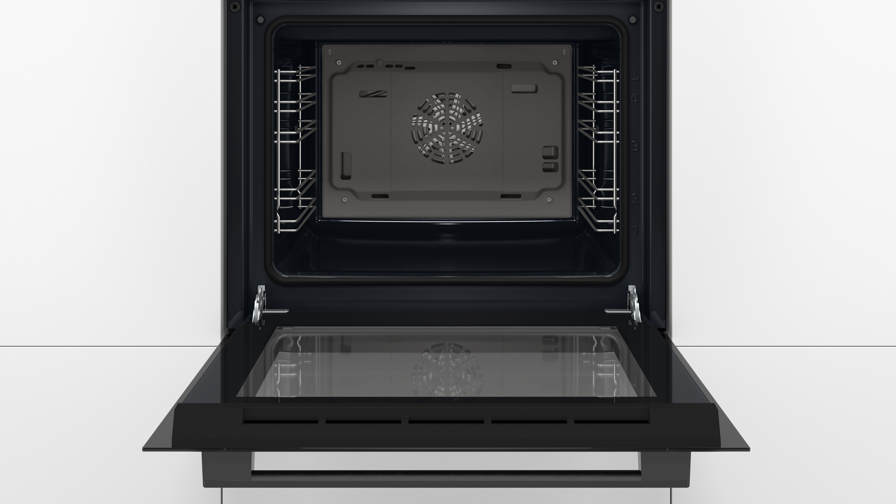 A close-up of a black stovetop with touch controls. The surface is clean.